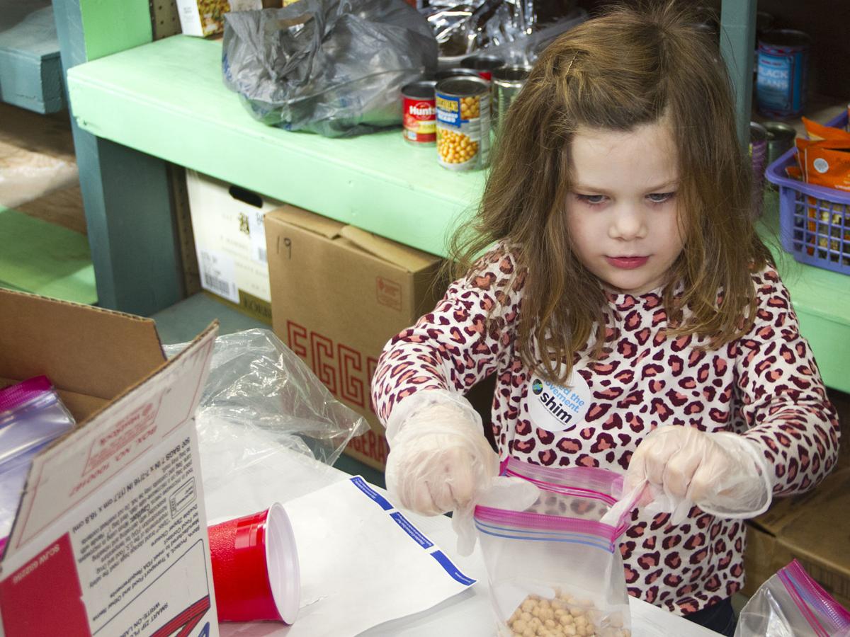Young girl packs beans