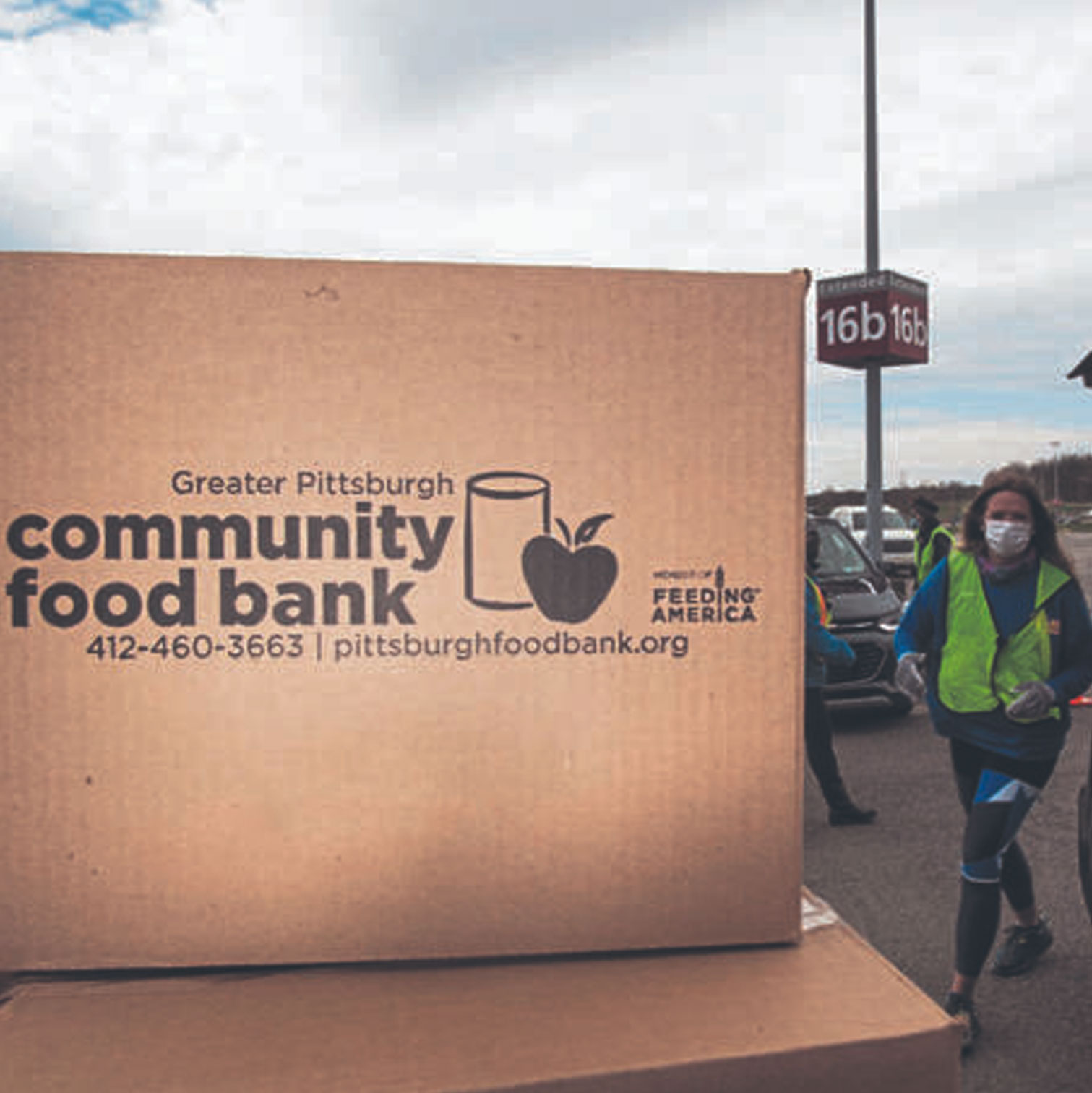 1000-F Boxes of food loaded into cars at food distribution
