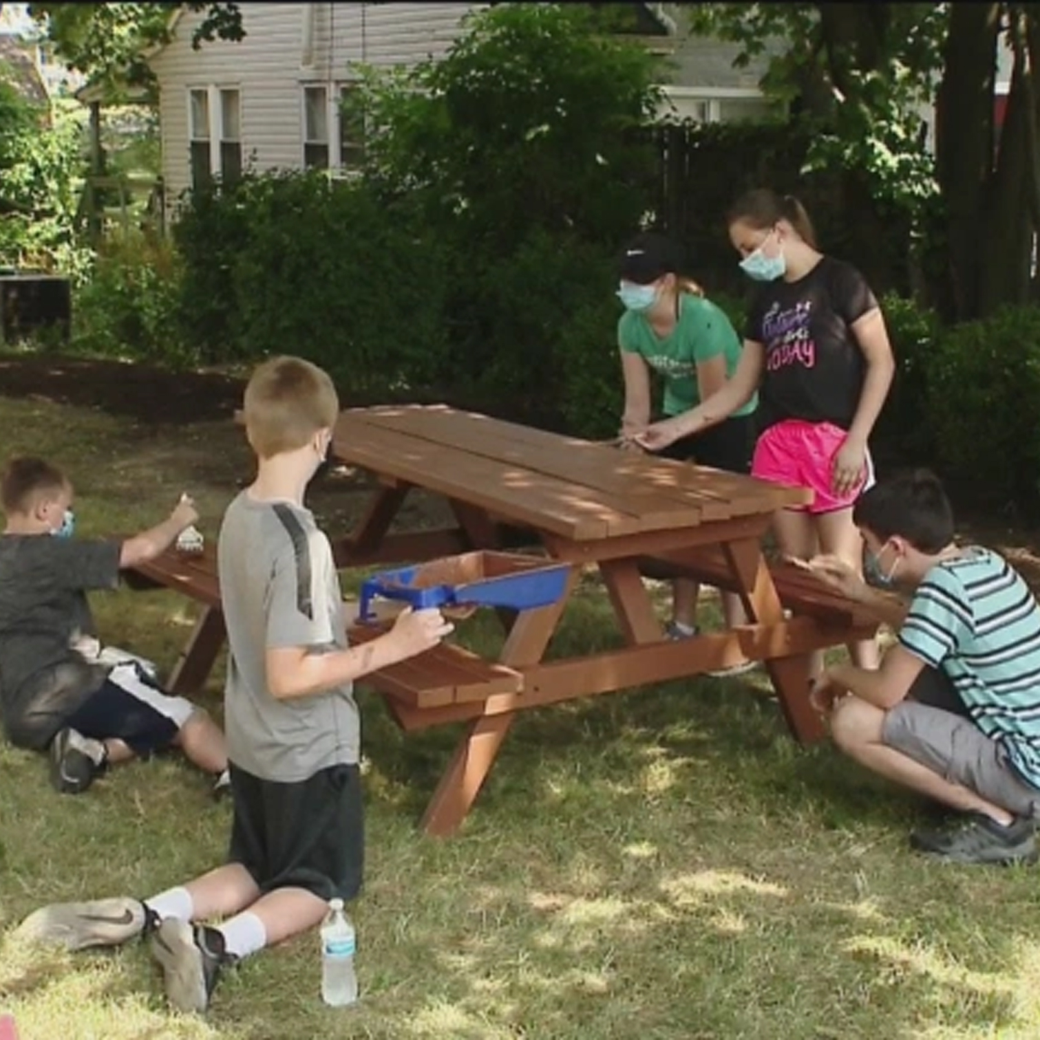 Positive Students are painting the picnic tables here at SHIM