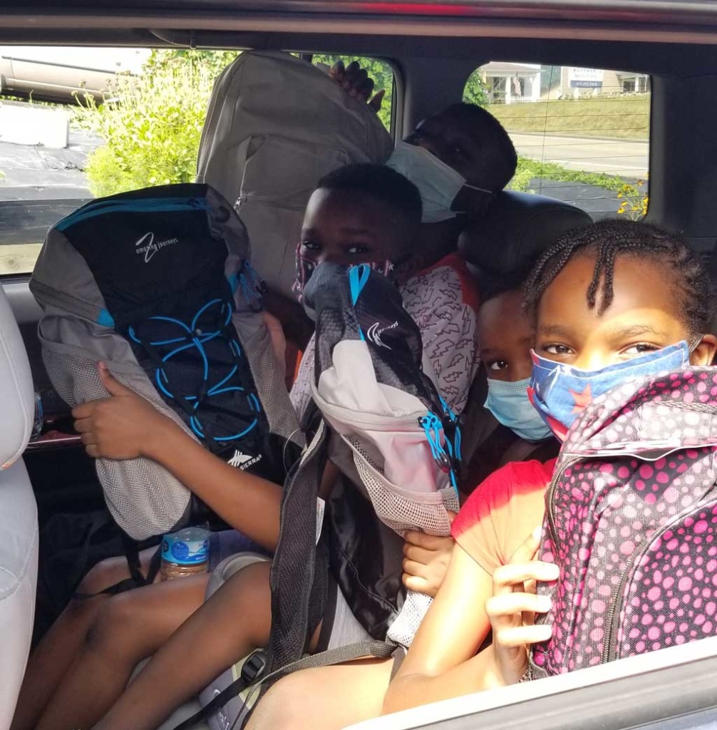Students in car receive book bag