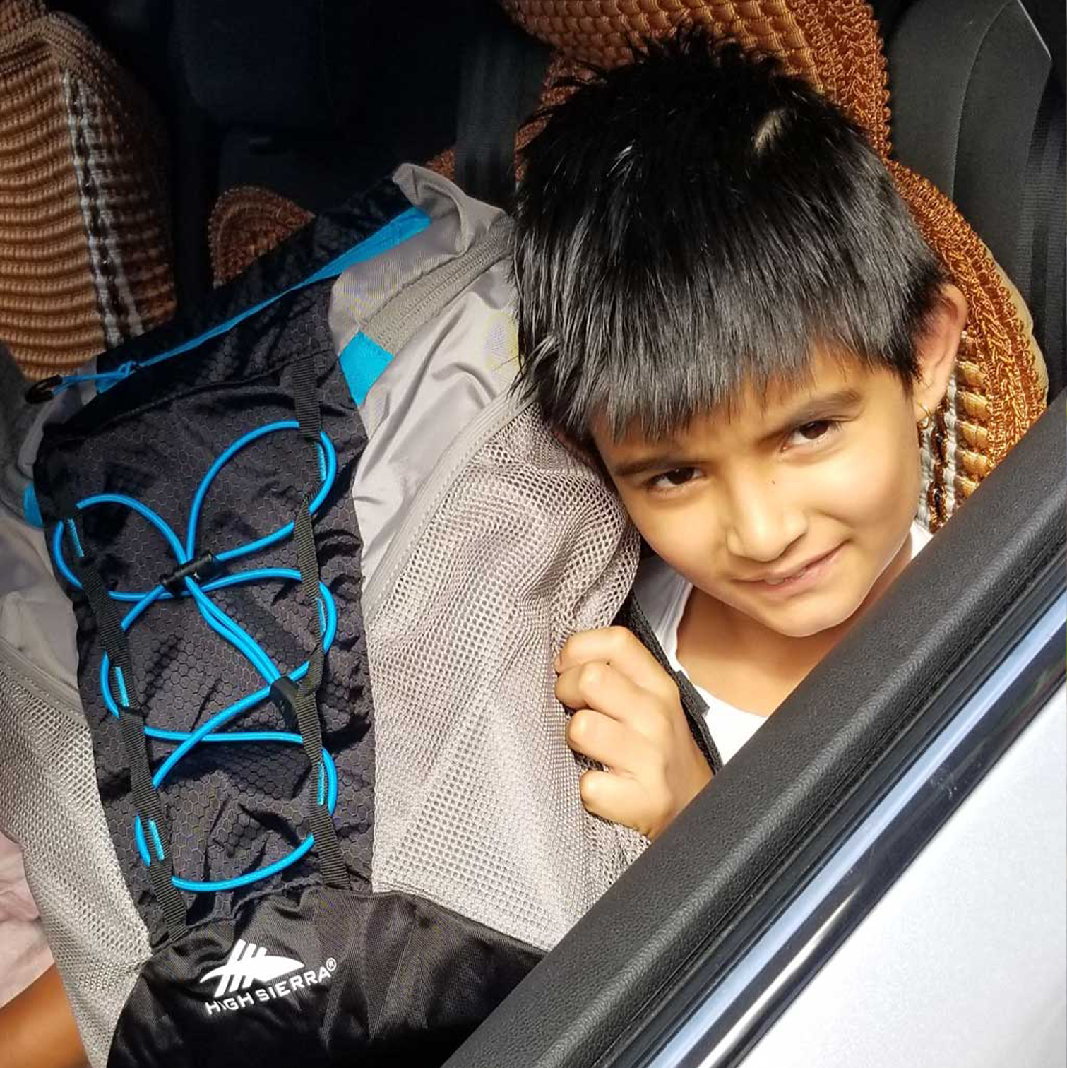 Bookbag-dist Student receives new bookbag
