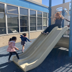 Stacey on slide with ECP kids