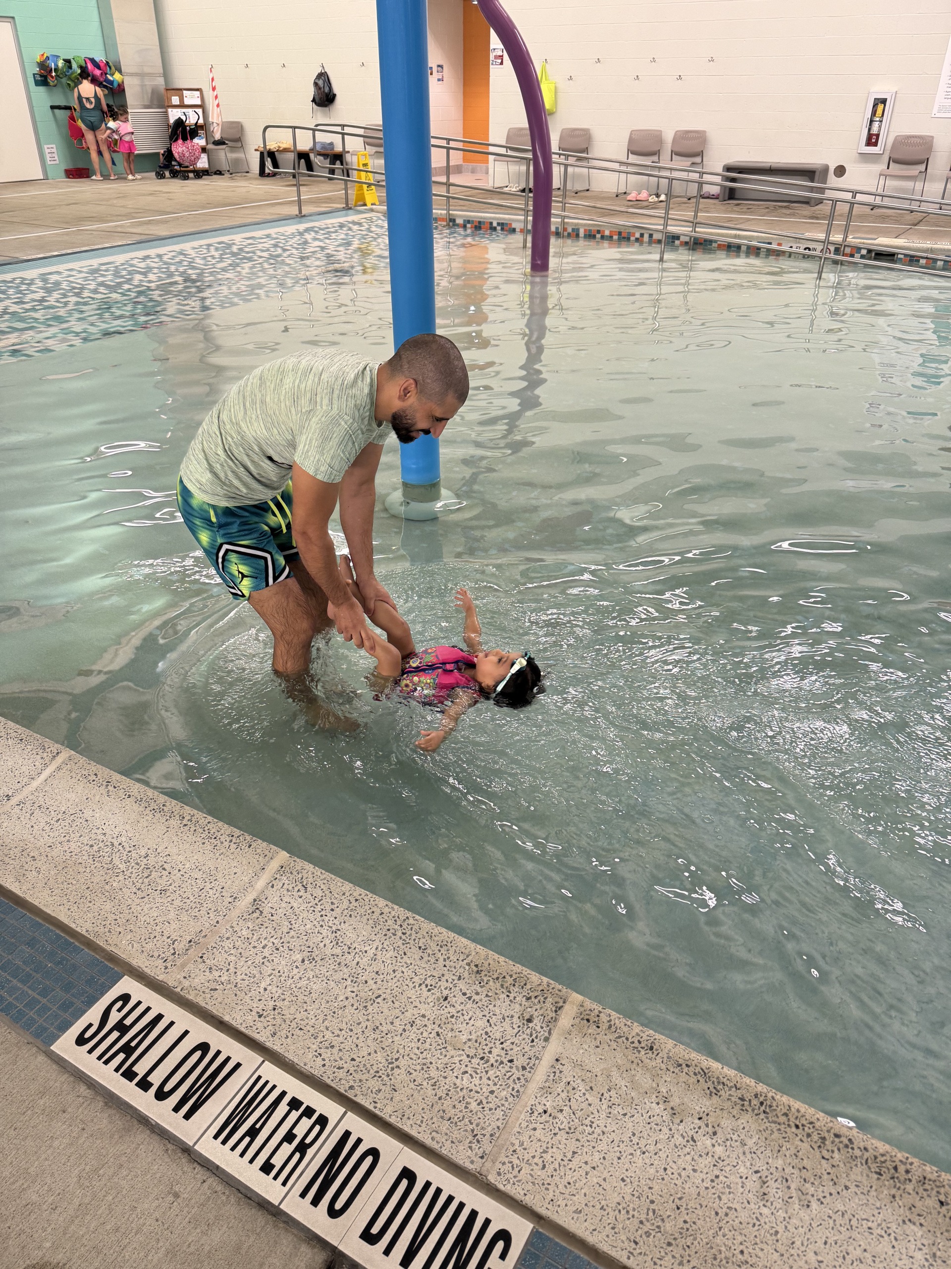 Youssef teaching daughter to swim Youssef teaching daughter to swim