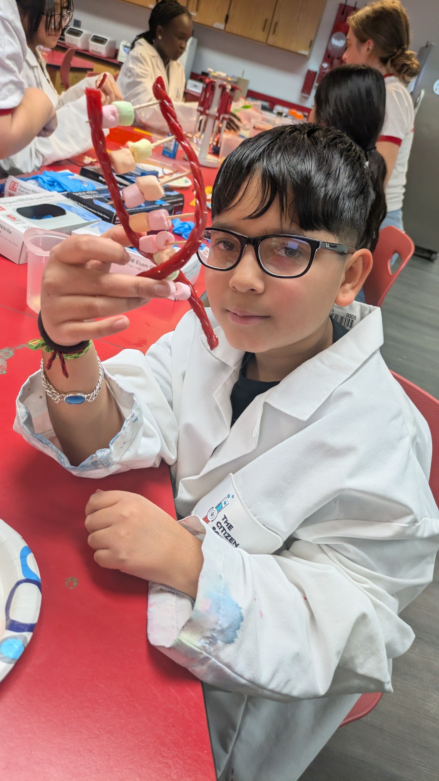 Youth Mentoring student building DNA helix out of candy