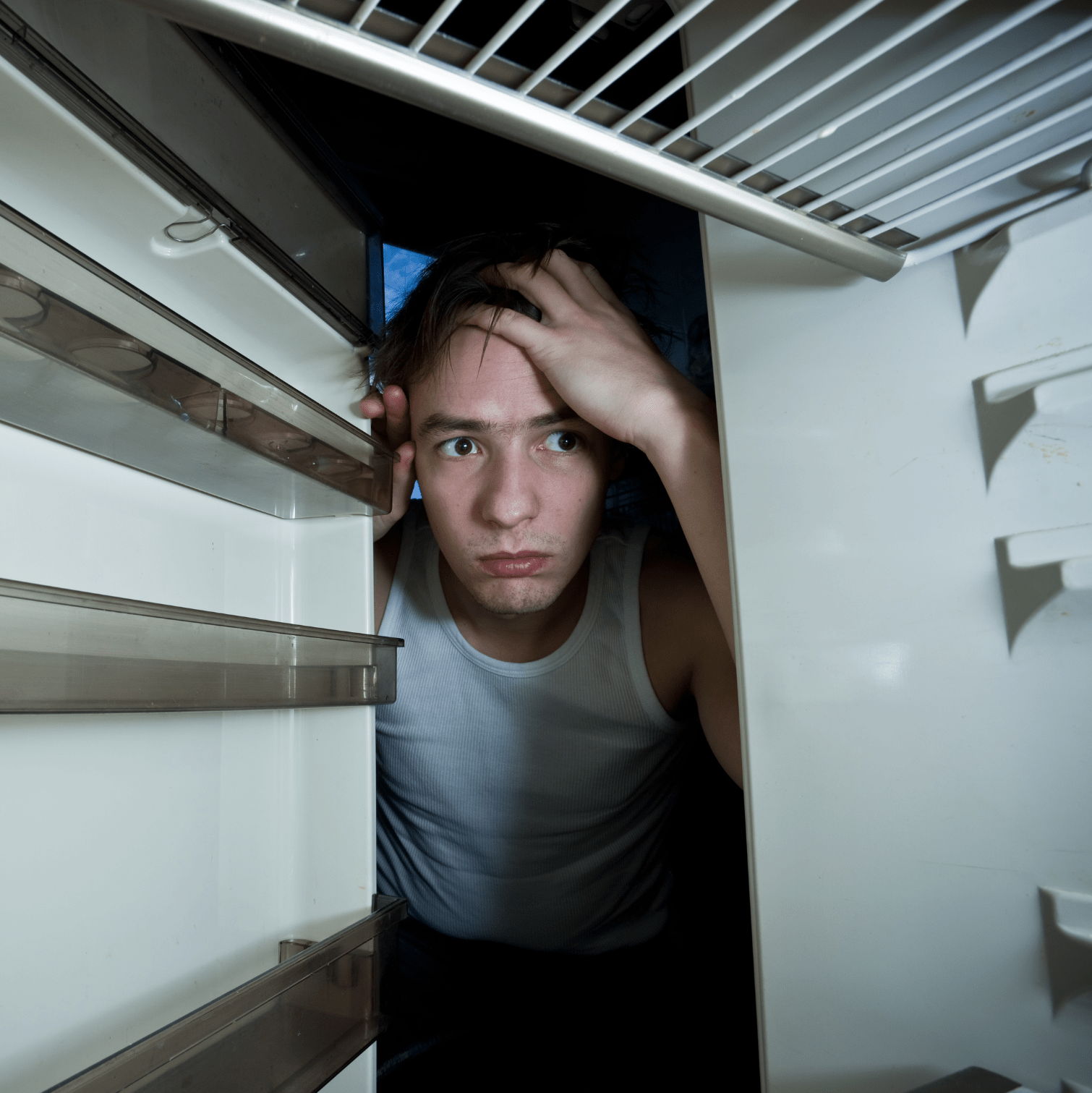Man looking into empty fridge Man looking into empty fridge