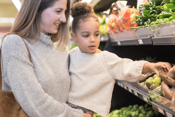 Woman with girl at grocery store
