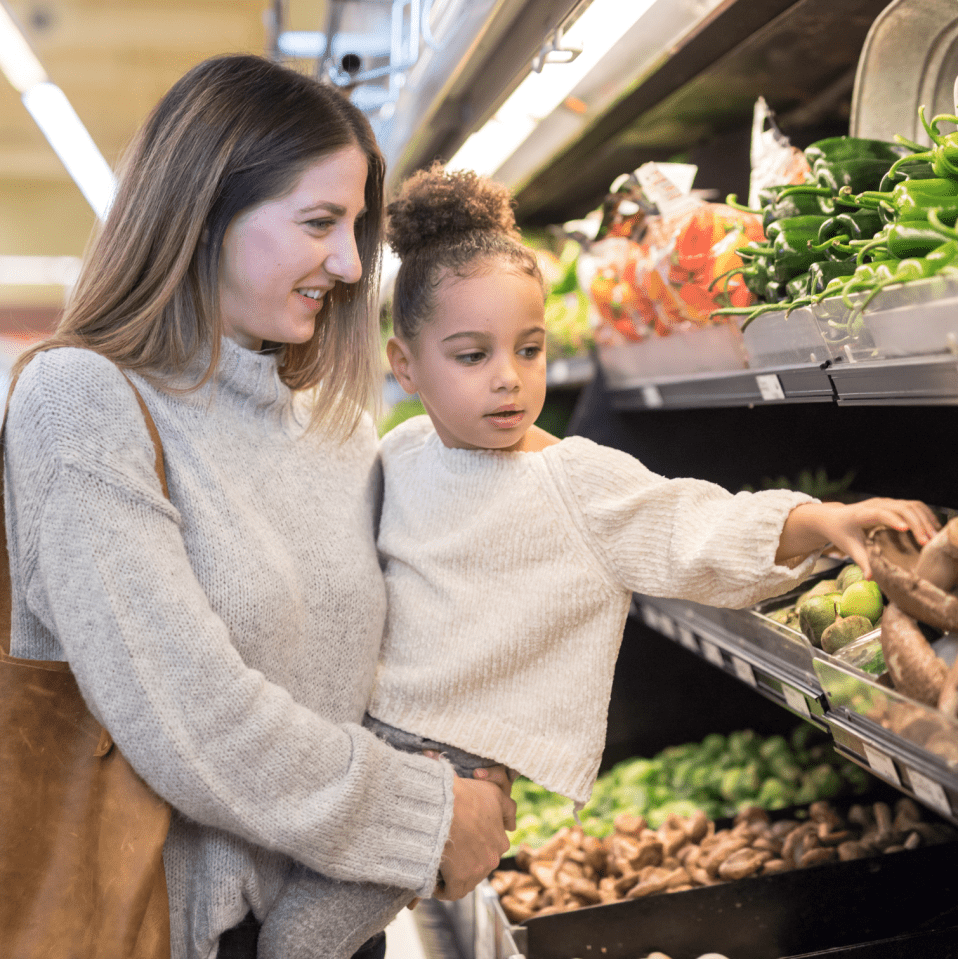 Woman with girl at grocery store